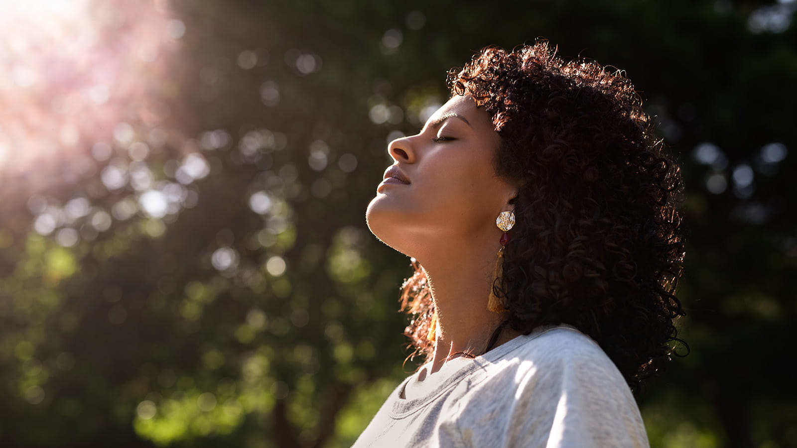 image of woman breathing in the sunshine