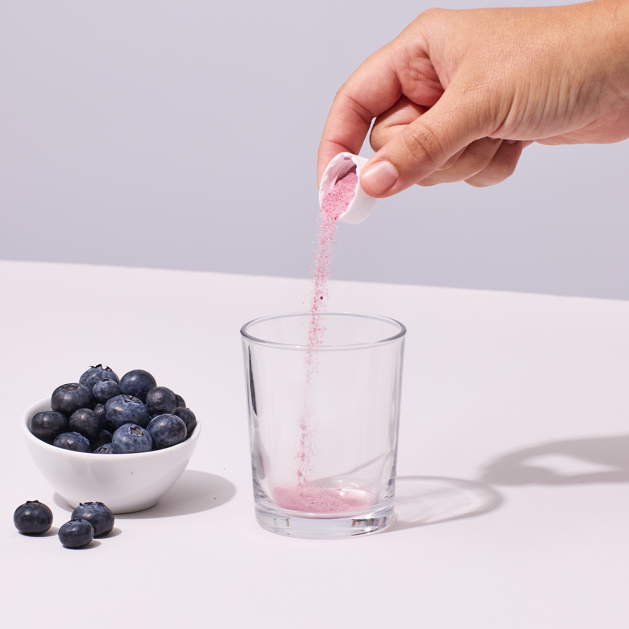 image of person pouring a serving of Isotonix Maximum ORAC powder into a glass
