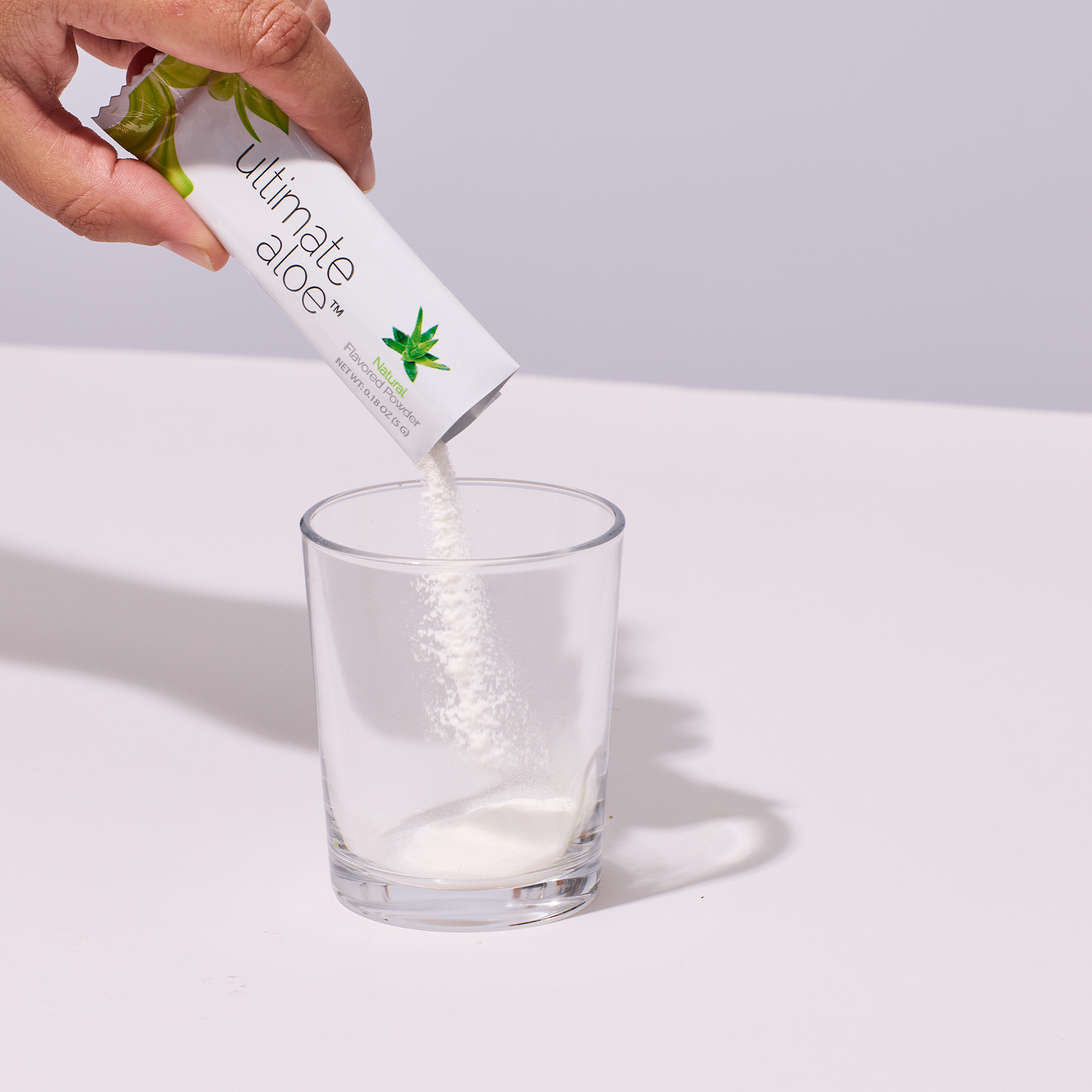 image of packet of powder being poured into a cup