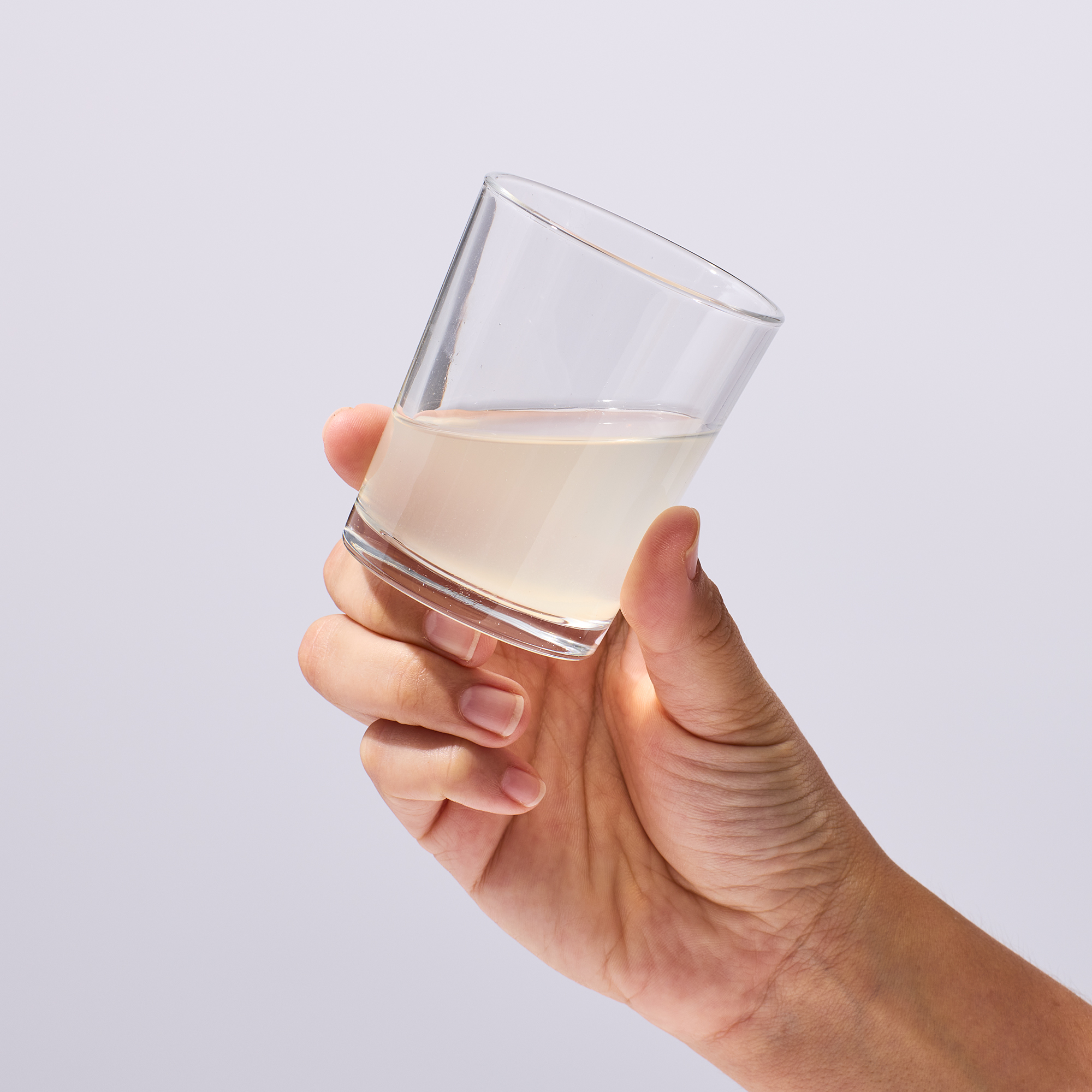 image of a person raising a glass of Isotonix Magnesium to drink