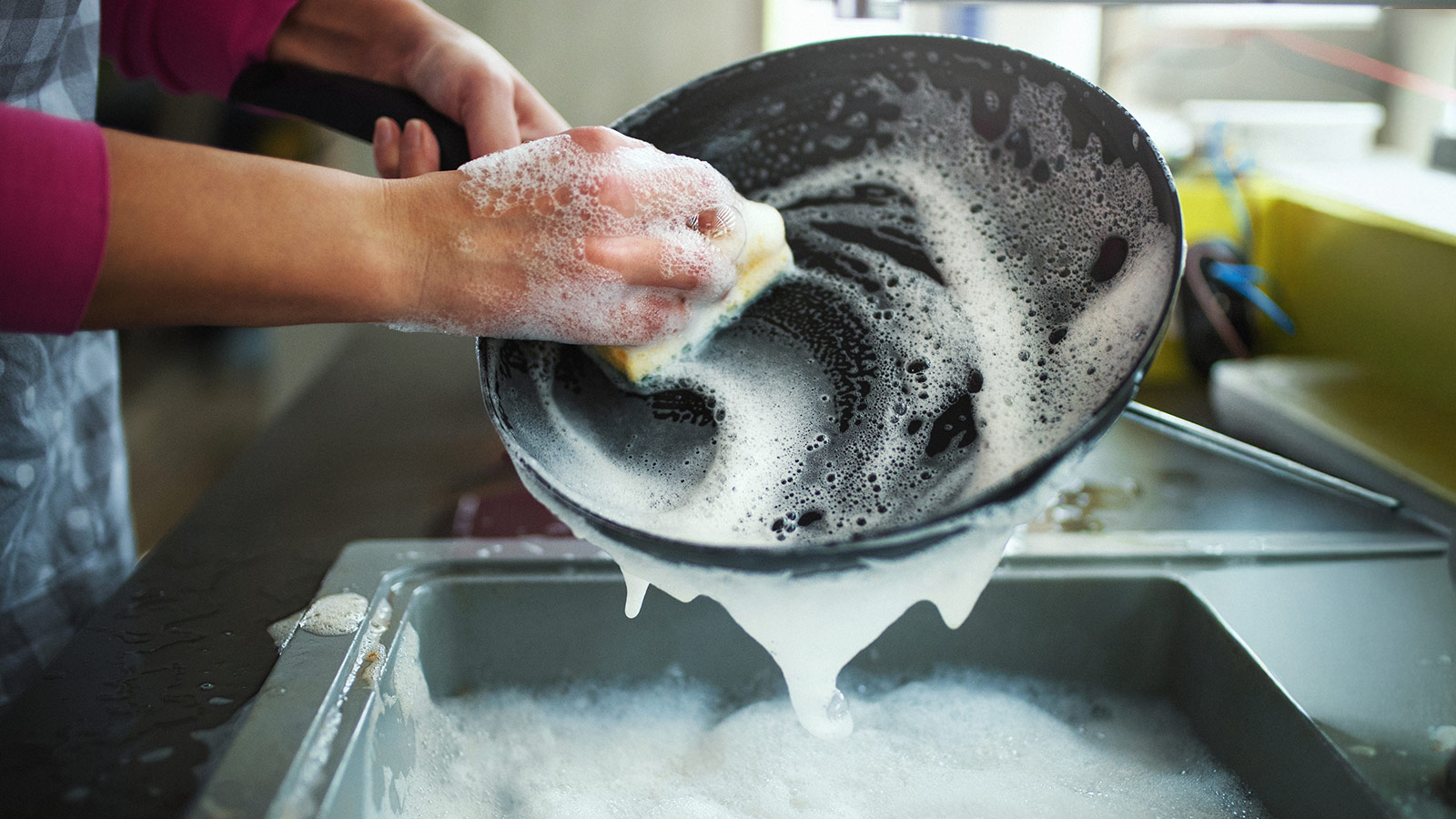 image of person cleaning pan