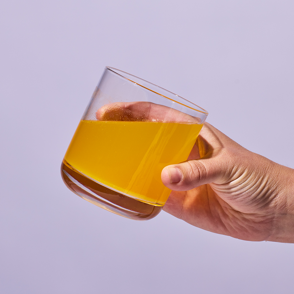 image of someone holding a glass containing one serving of Isotonix Turn Down