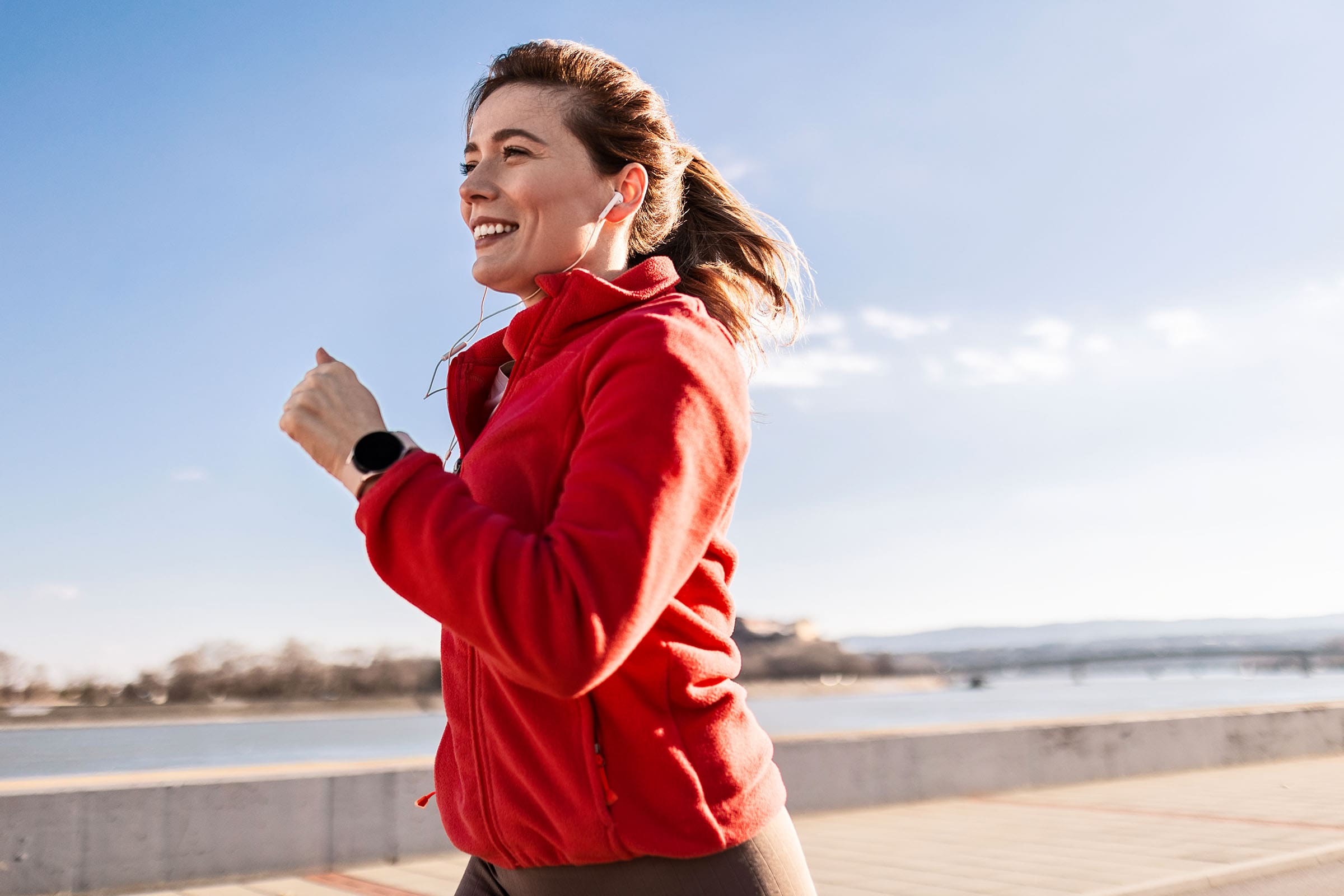 Image of woman in a red jacket running