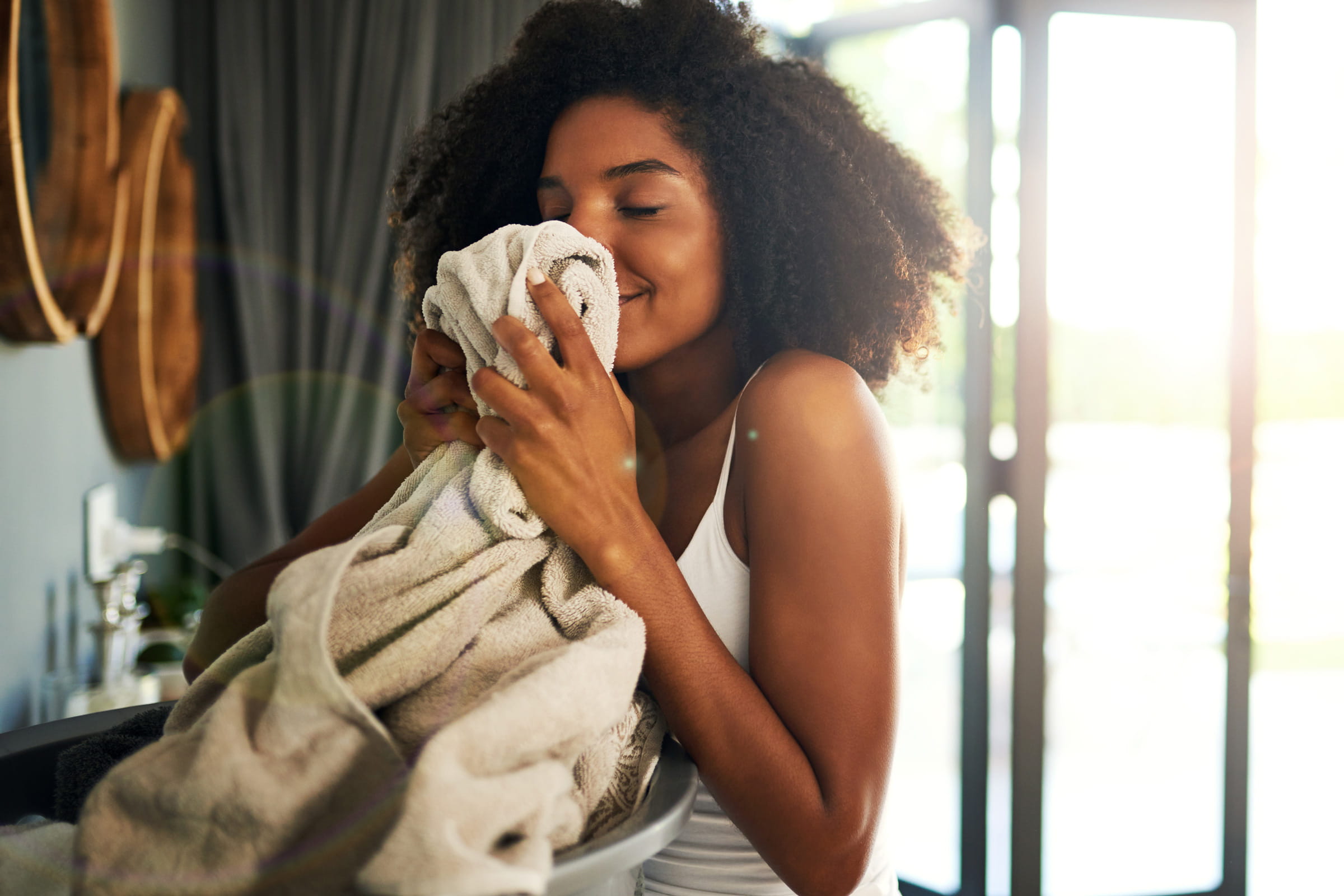image of woman smelling fresh laundry