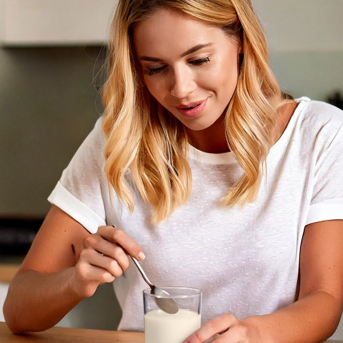 Image of person mixing colostrum powder with water 