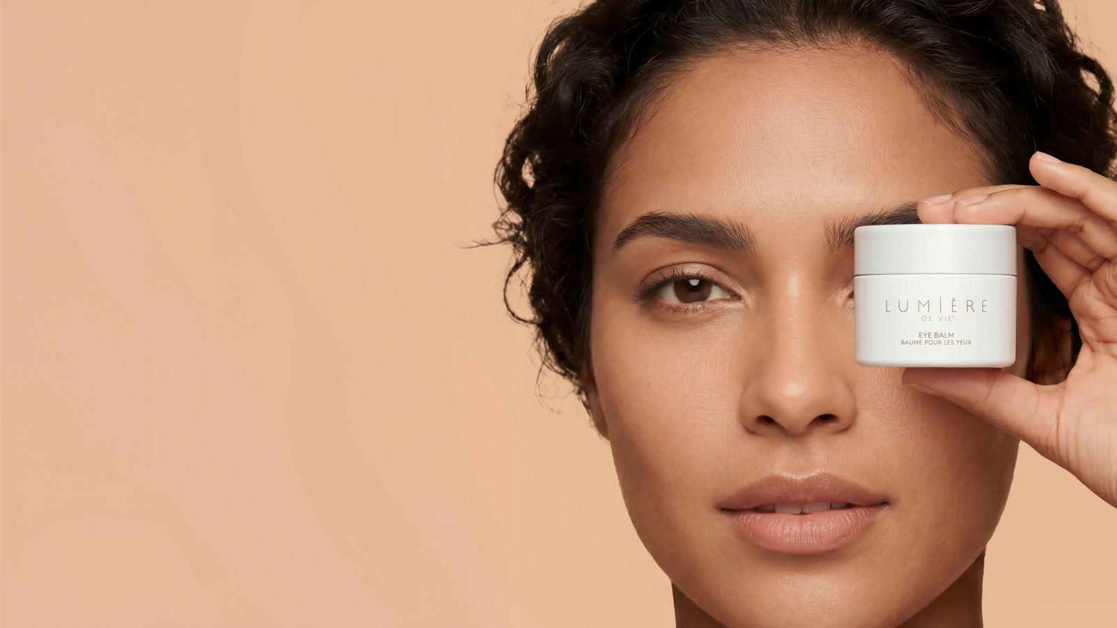 woman holding eye balm