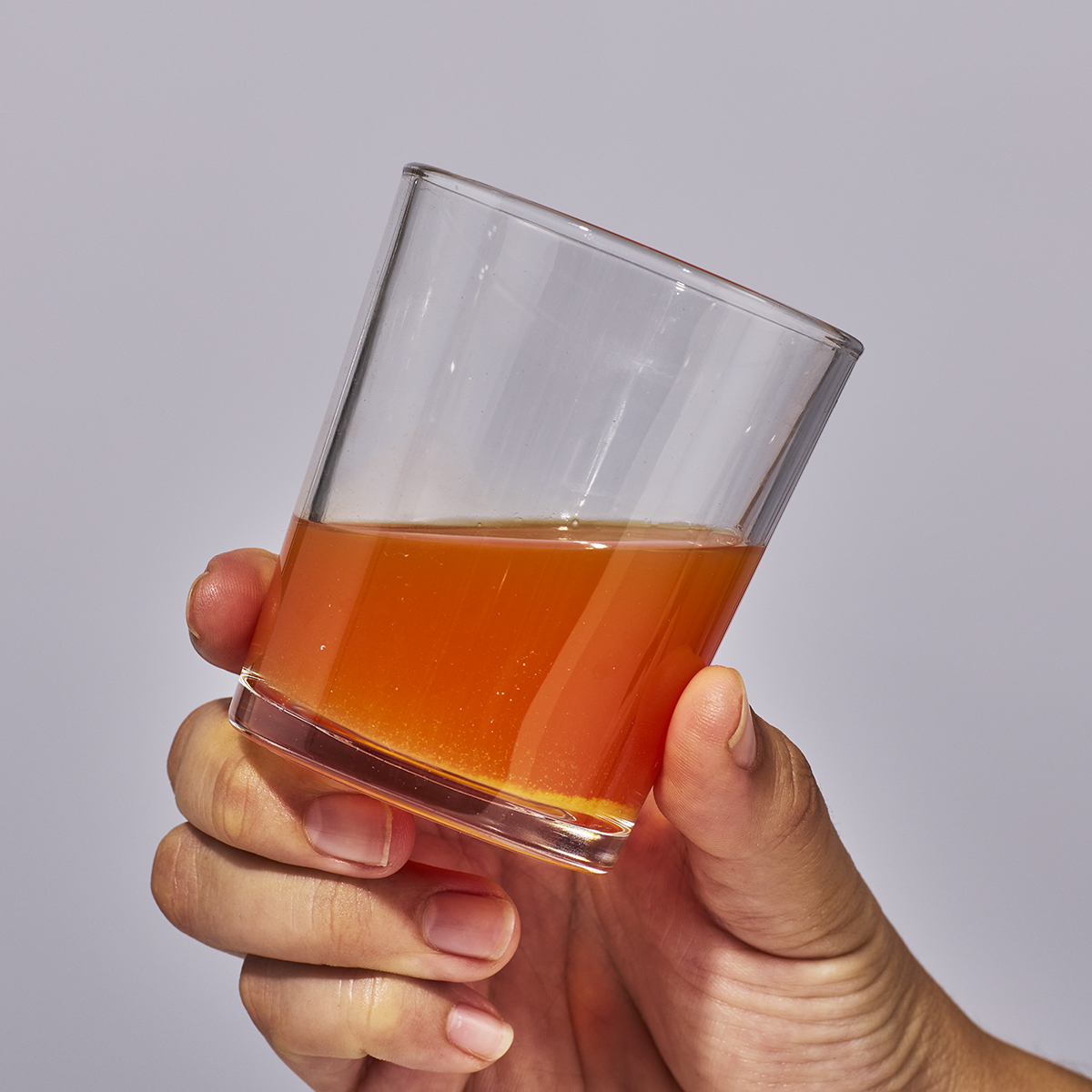 image of person holding a glass containing one serving of Isotonix Vision with Lutien