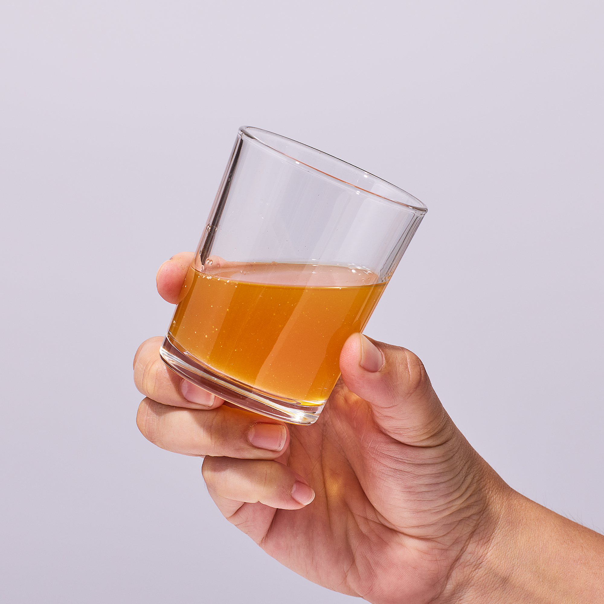 image of person raising cup to drink