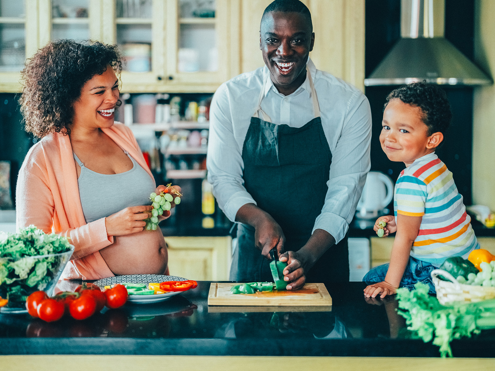 image of a family preparing a meal in the kitchen together