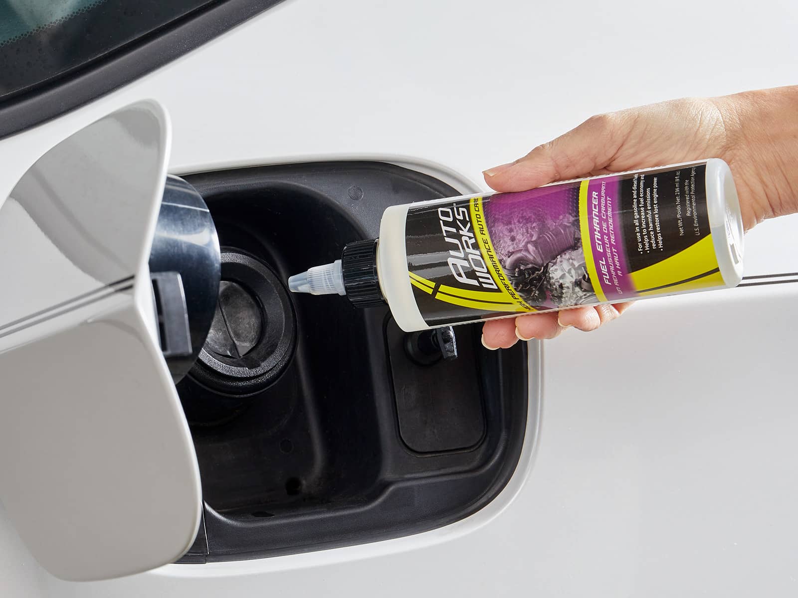 image of someone adding Autoworks Fuel Enhancer to their car