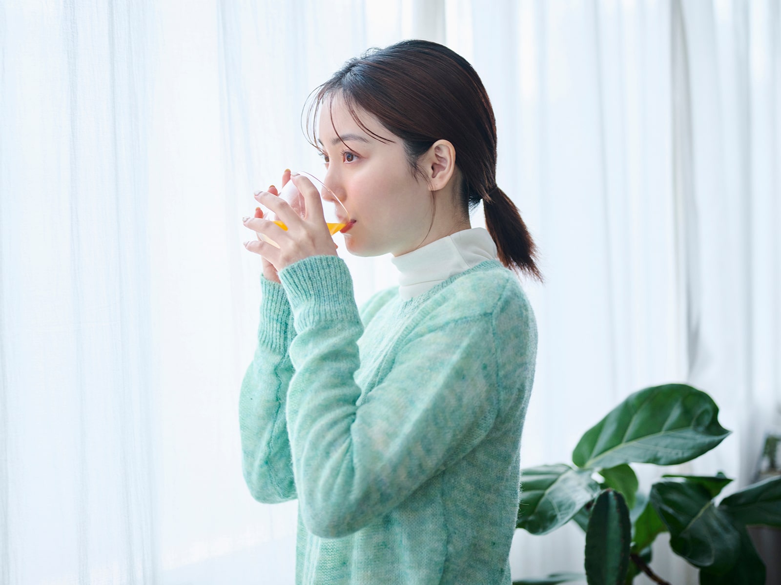 image of a woman drinking out of a glass.