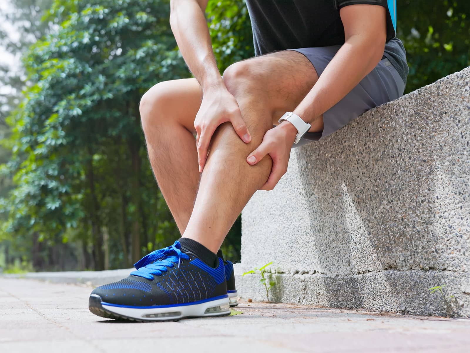 image of person holding his leg muscle