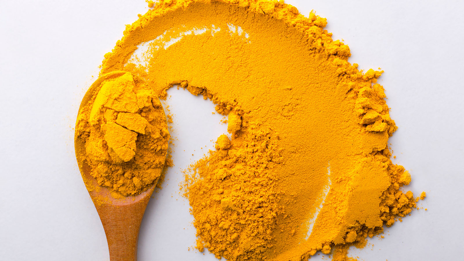 Image of curcumin powder and a spoon