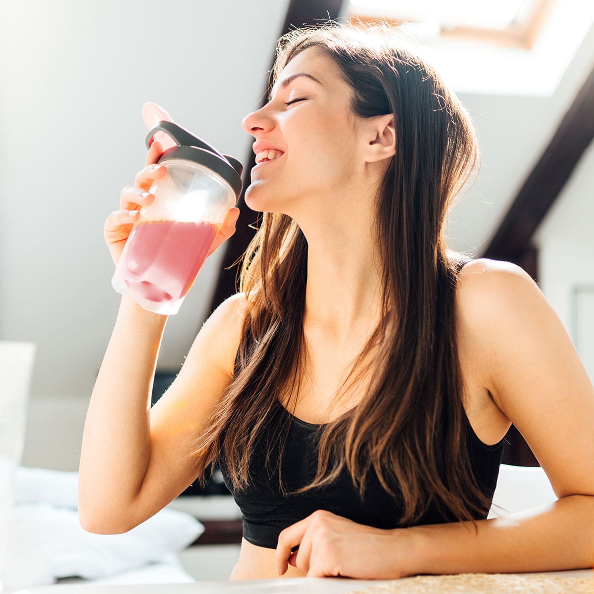 image of woman drinking mixed product