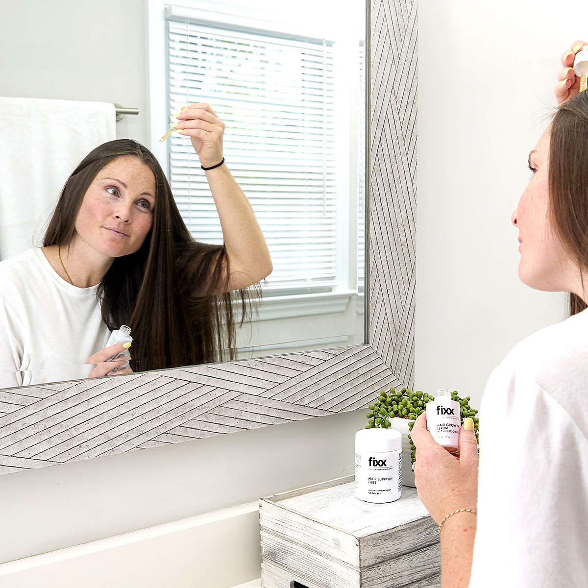 image of woman applying serum to scalp