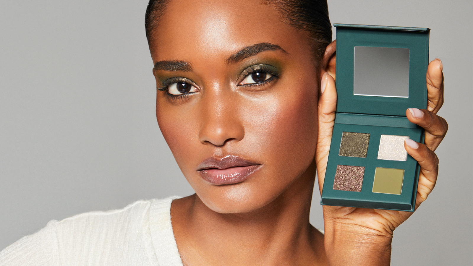 Woman holding the Enchanted palette next to her face