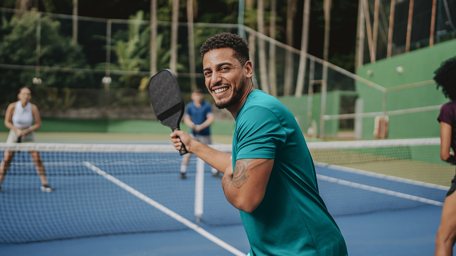 image of healthy person playing tennis on tennis court.