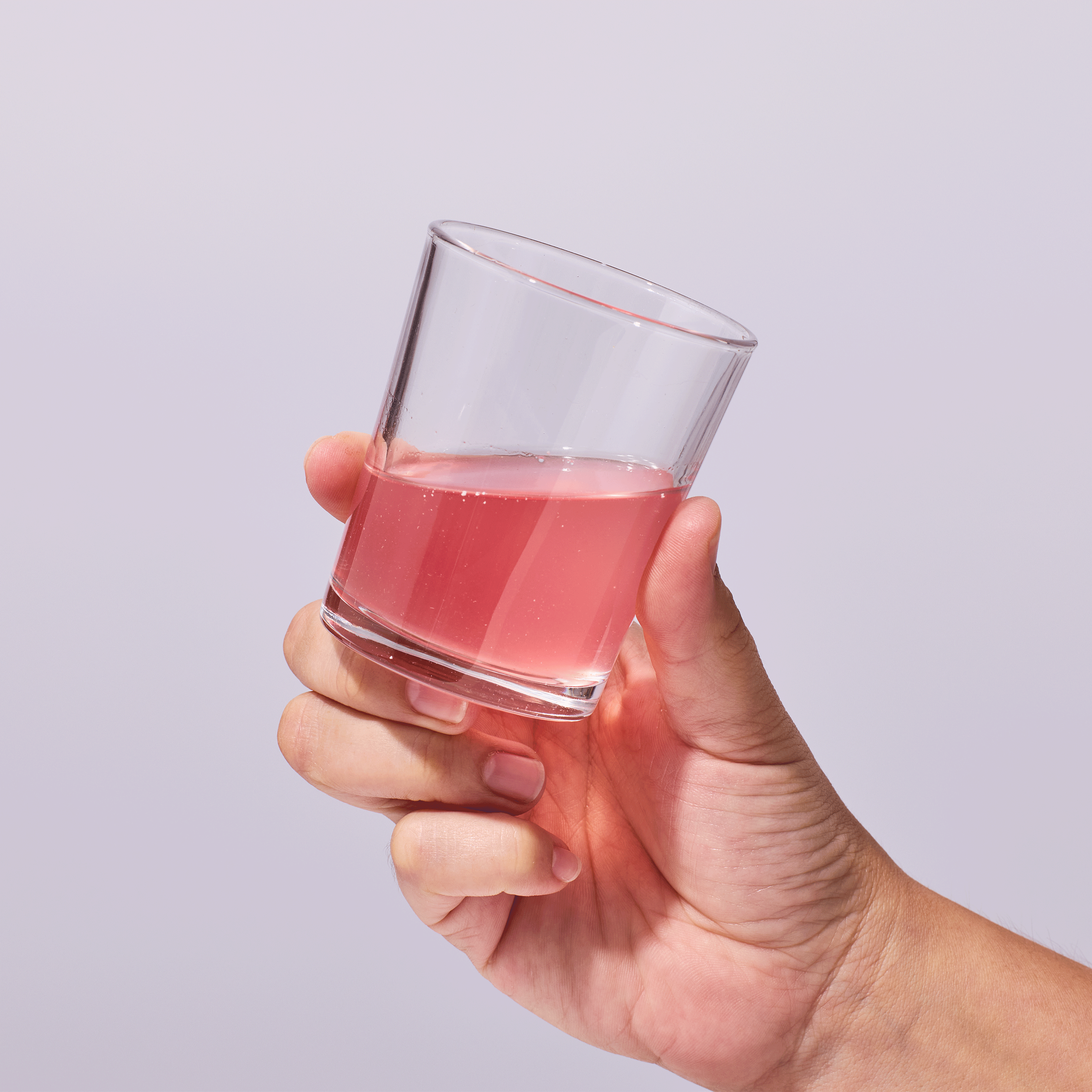 Person holding cup with Isotonix mixed product.