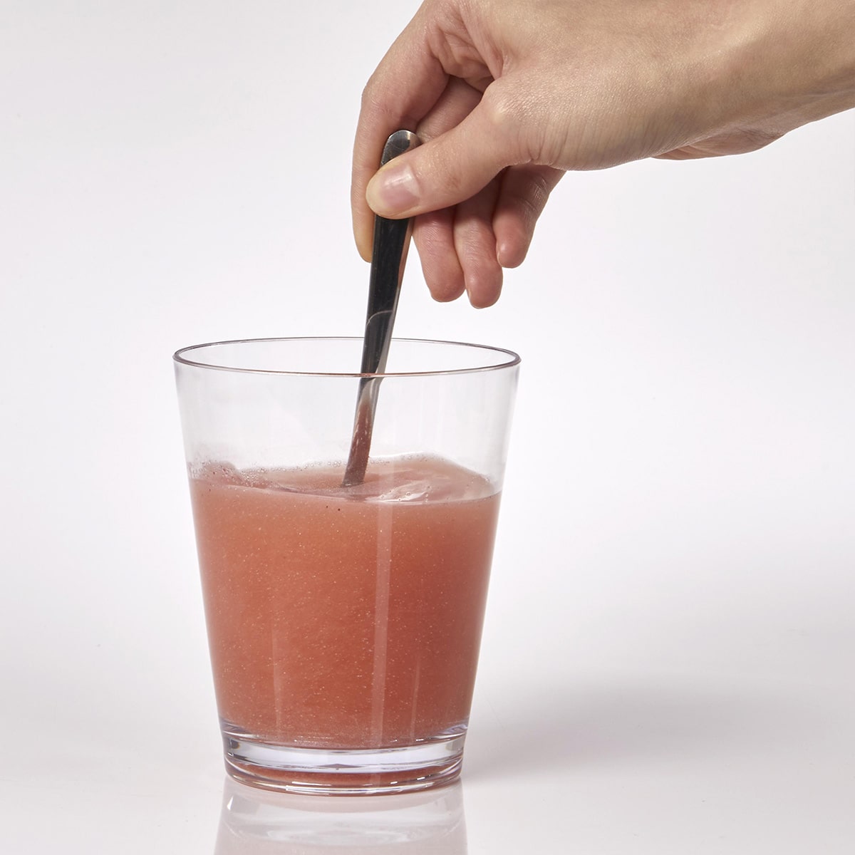 image of person mixing Isotonix Daily Essentials with water