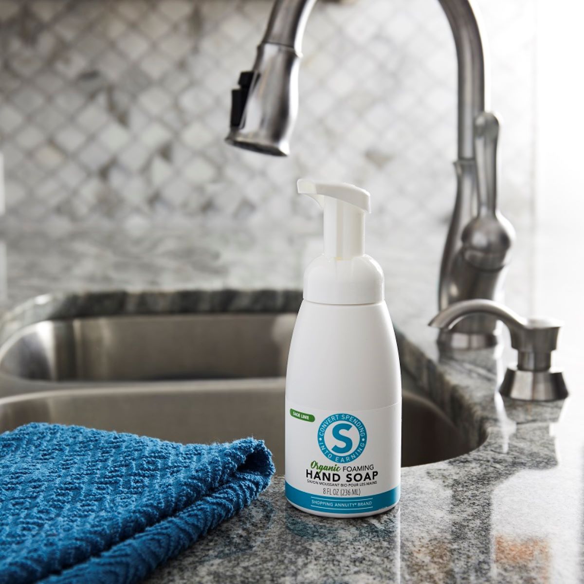 image of soap bottle and towel beside sink