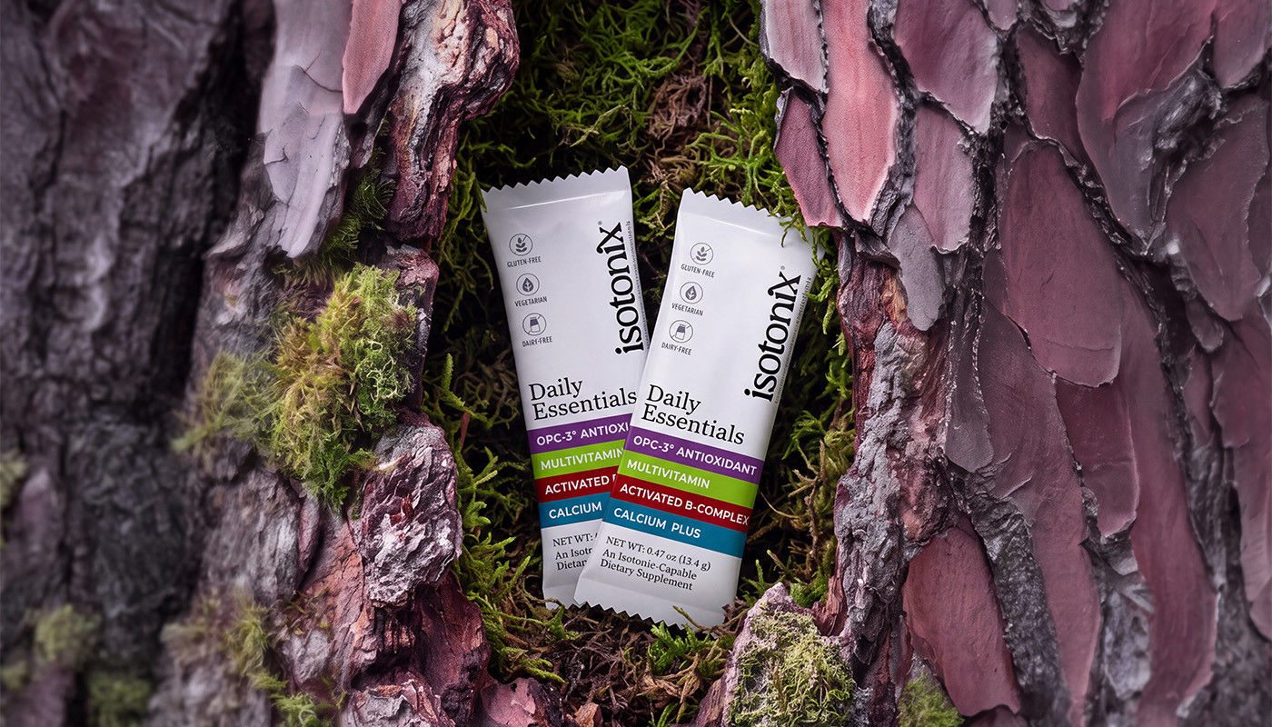 image of 2 Isotonix Daily Essentials Packets nested inside mossy bark