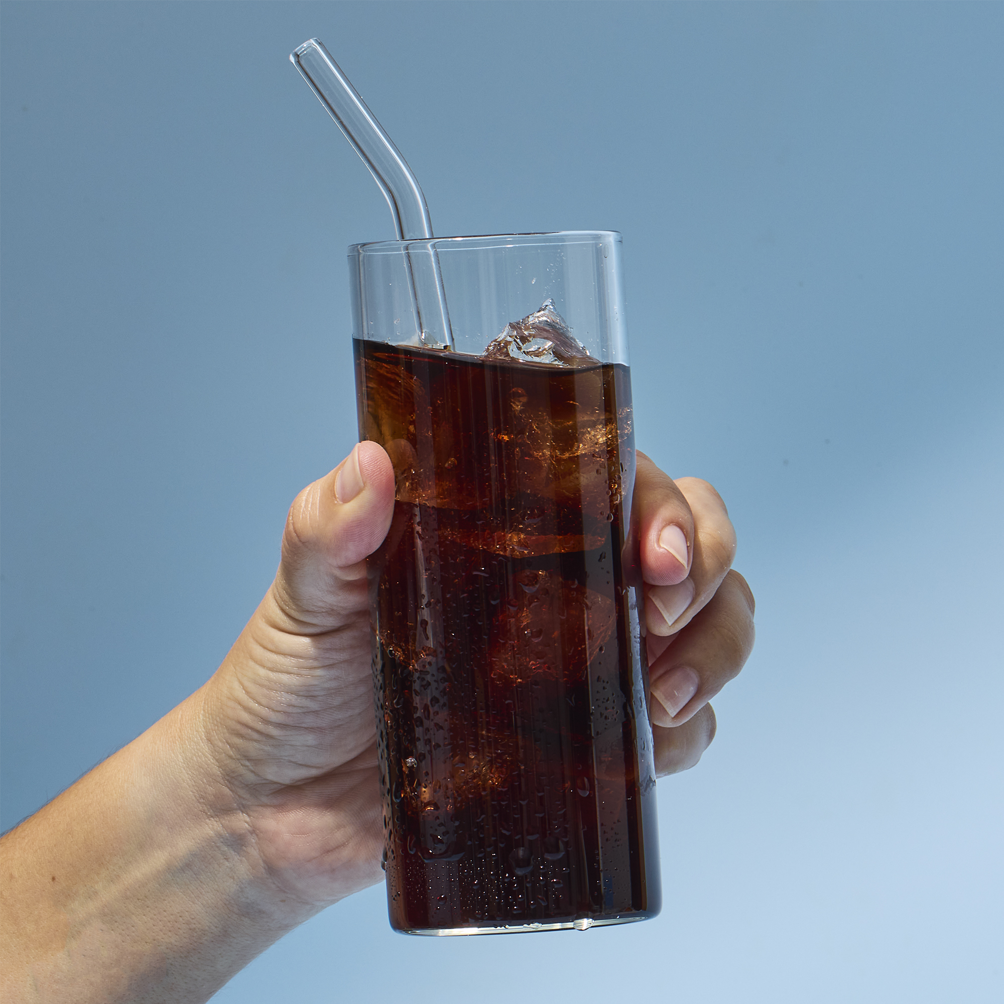 image of someone picking up glass with a serving of GoTrim Tea in it