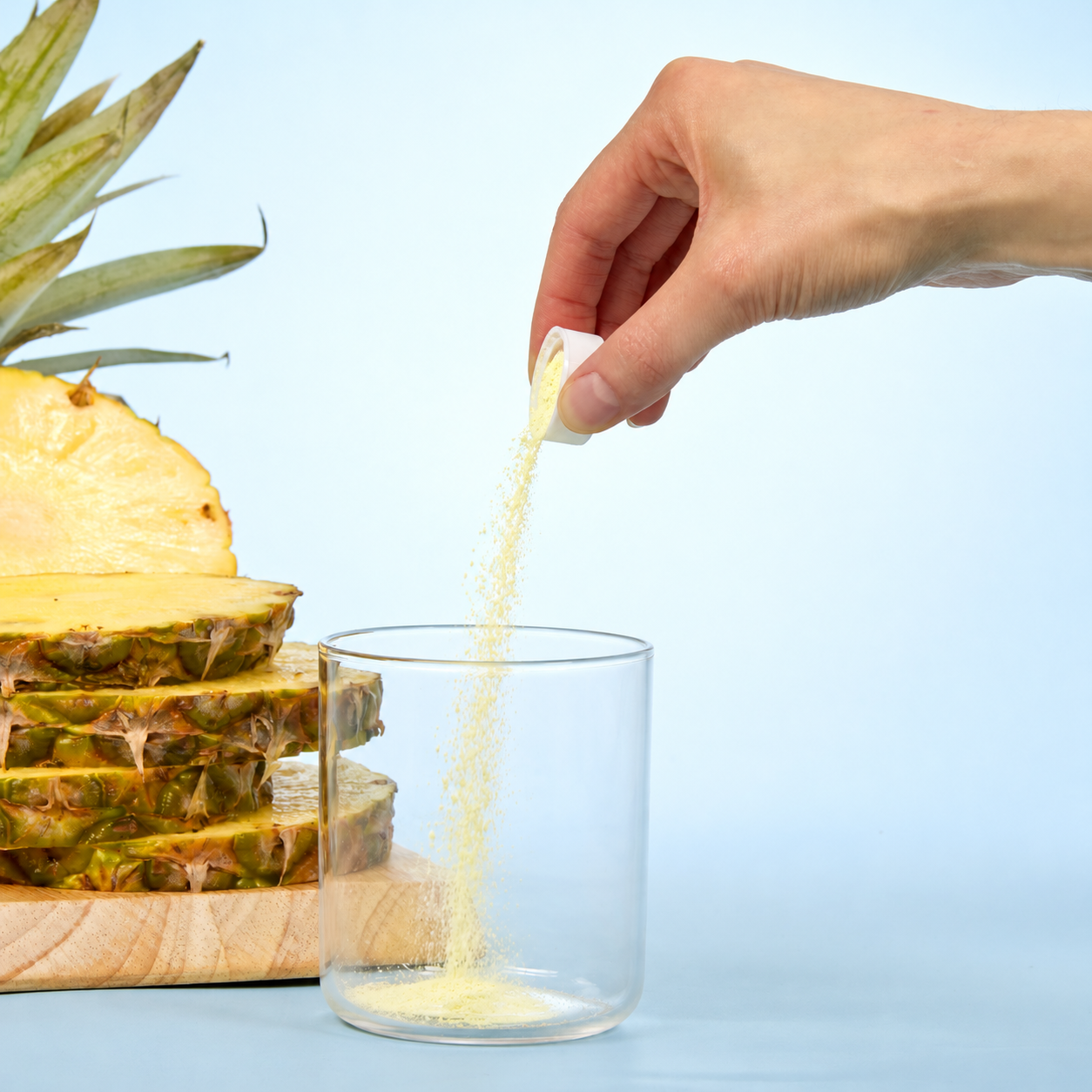 image of person adding capful of powder to glass