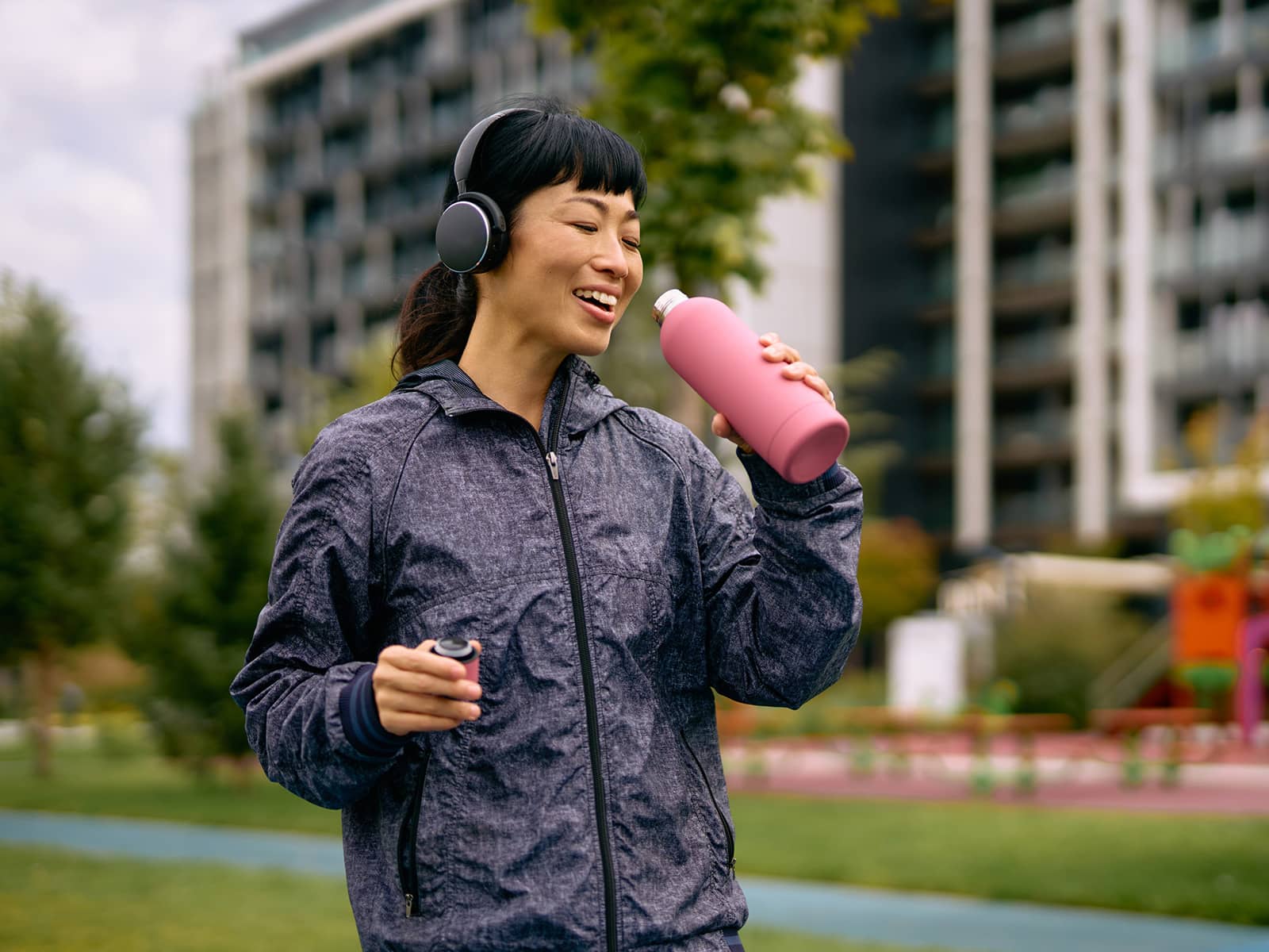 image of woman smiling and drinking water
