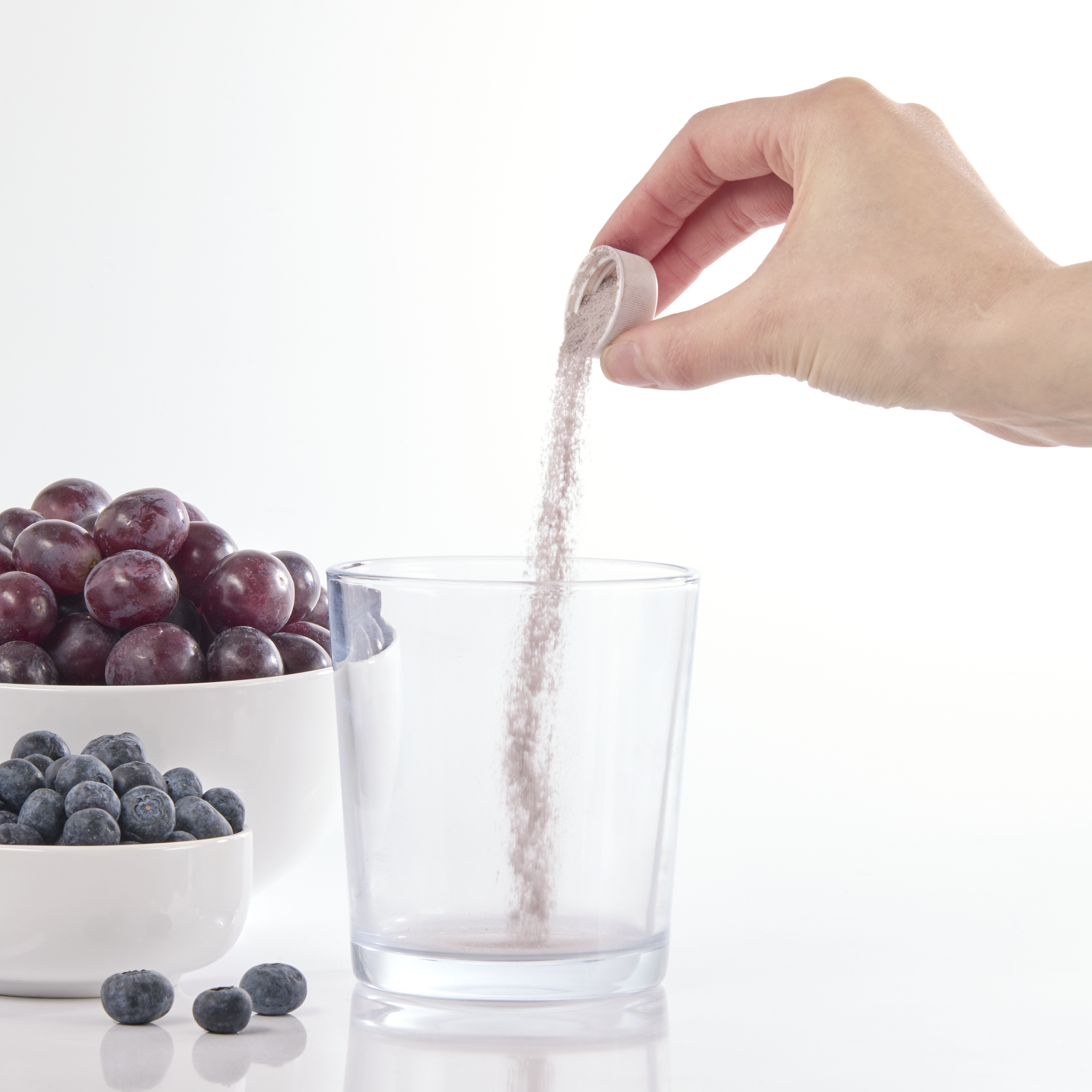 image of powder being poured into overcap