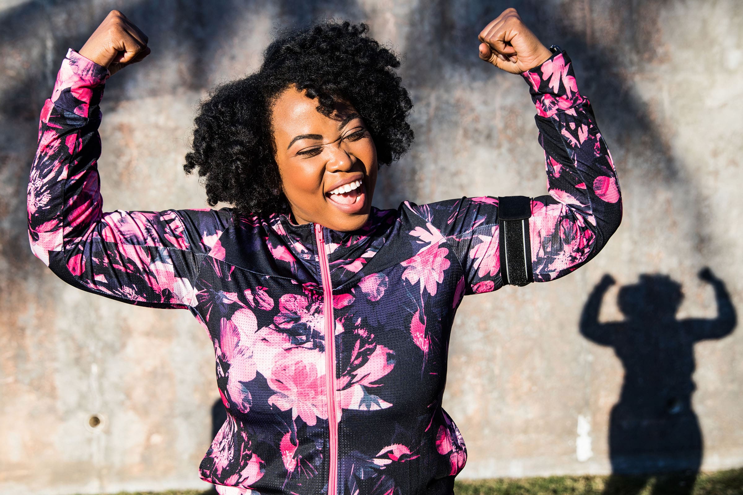 image of woman raising arms and cheering