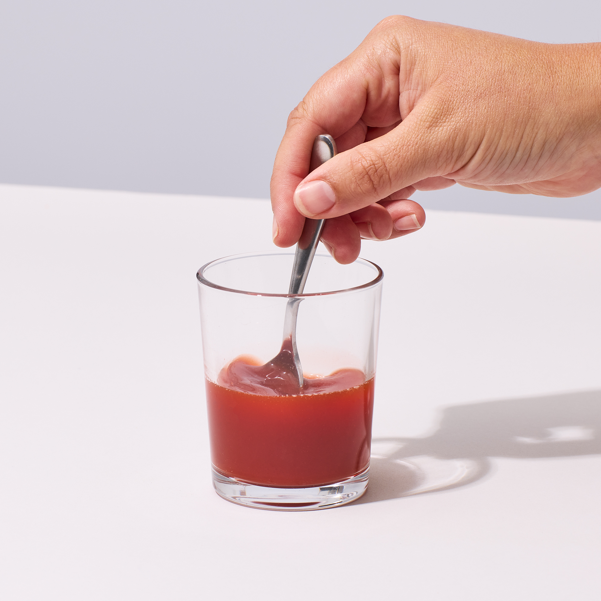 image of person stirring water and powder