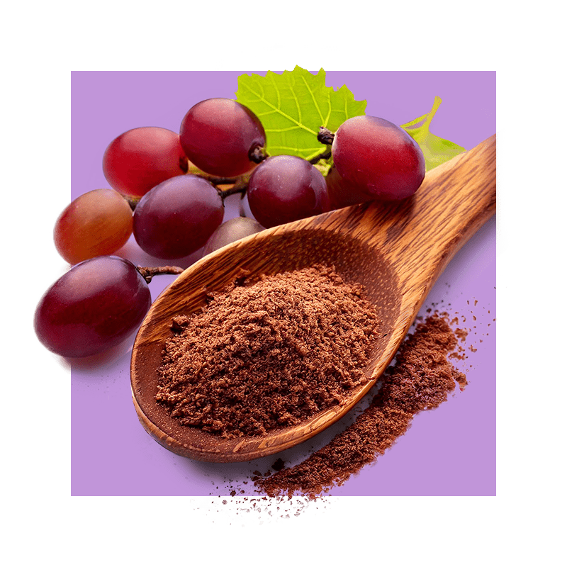 image of powdered grape skin in wooden spoon next to grapes