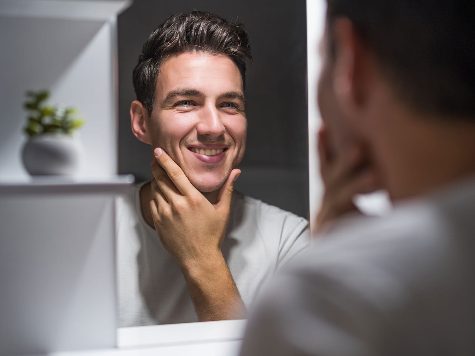 image of a man touching his smooth face