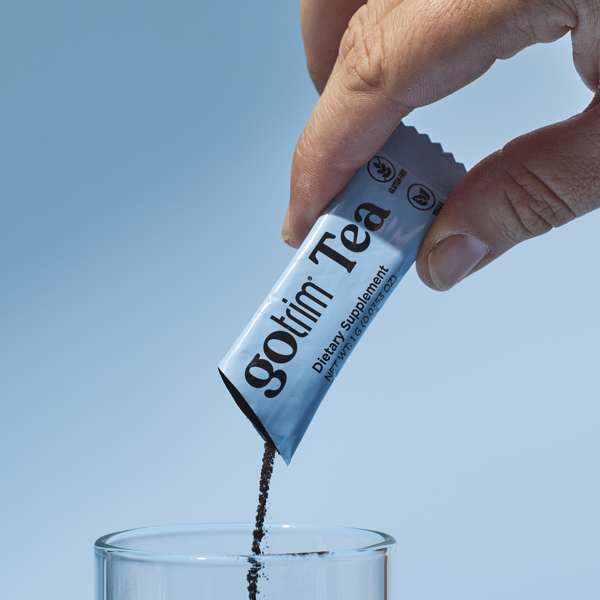 image of someone mixing a packet of GoTrim Tea into a glass
