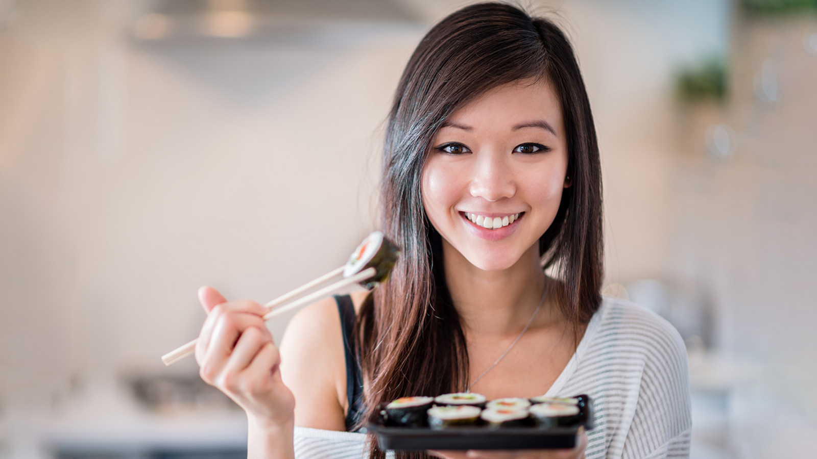 image of young woman with sushi