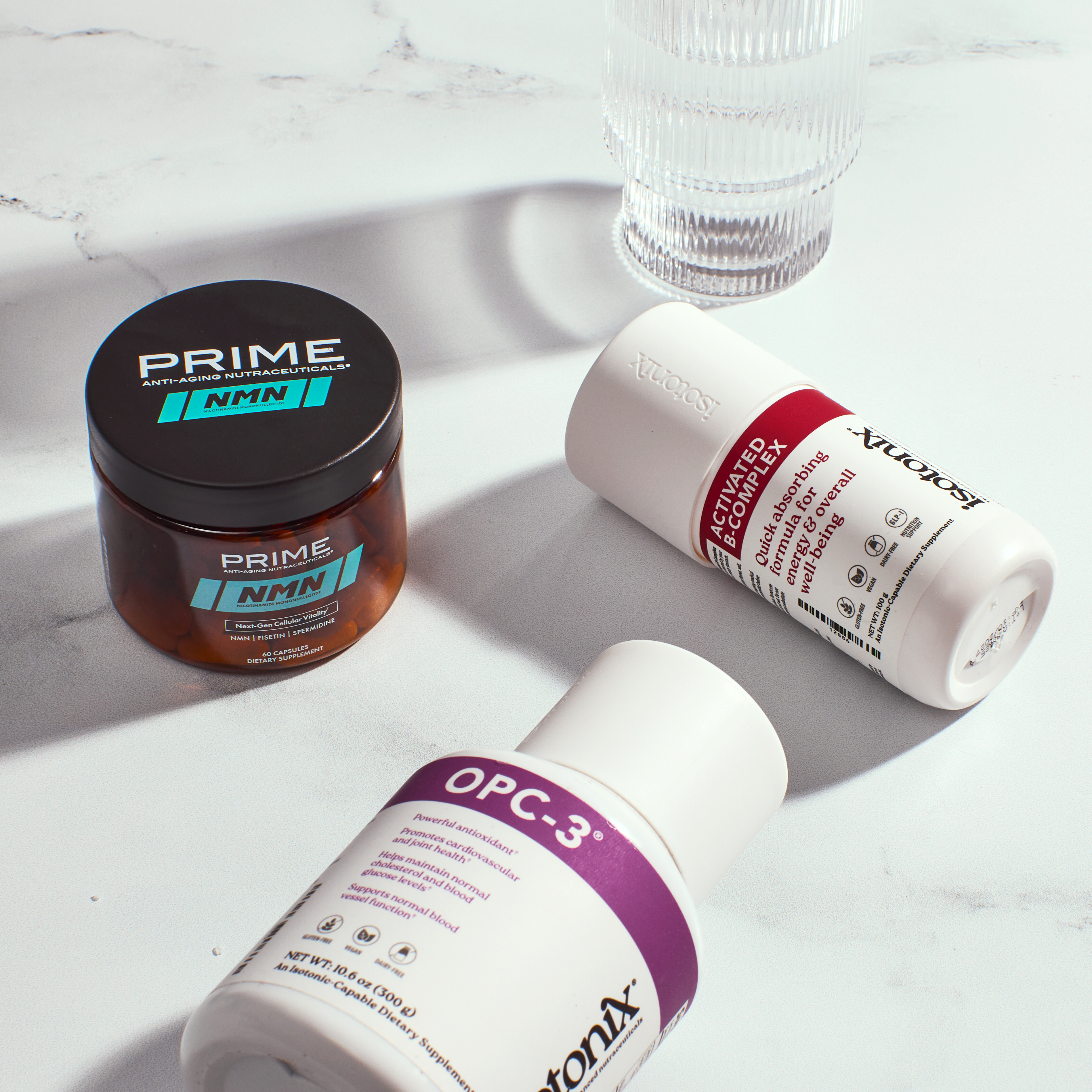 Prime NMN next to Isotonix Activated B Complex and Isotonix OPC-3 product bottles