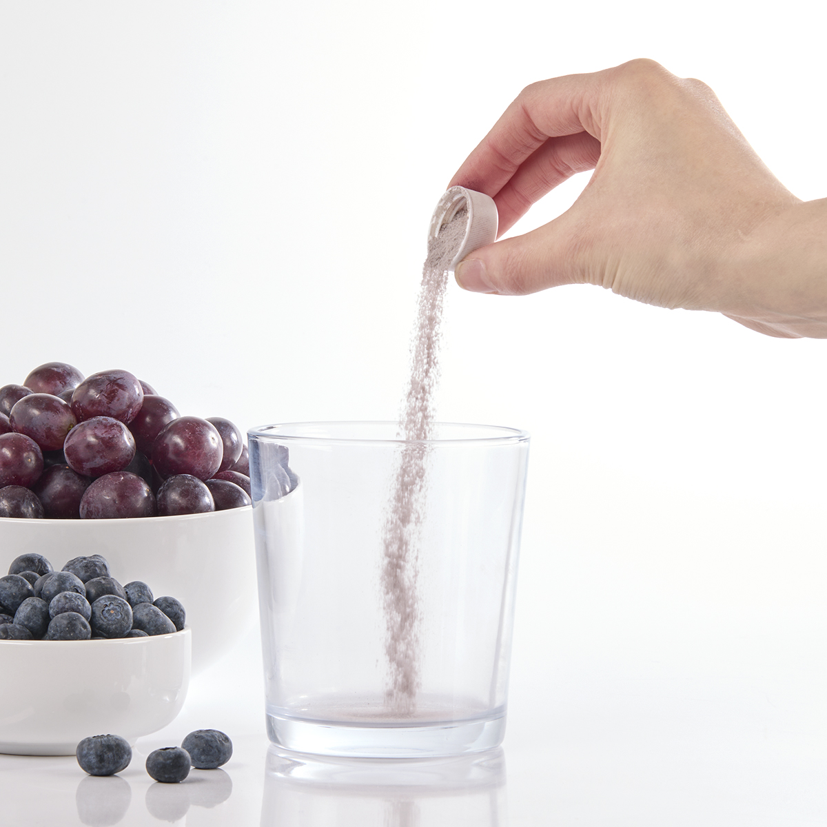 image of powder being poured into overcap