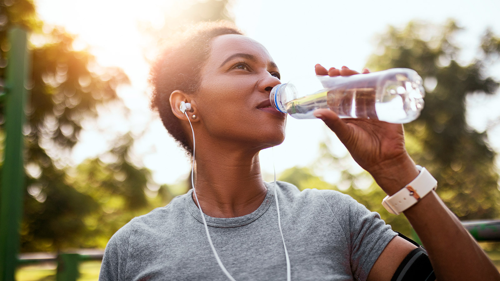 image of a woman drinking out of a water bottle