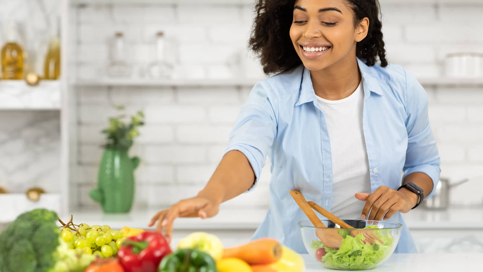 image of a person in the kitchen making a salad