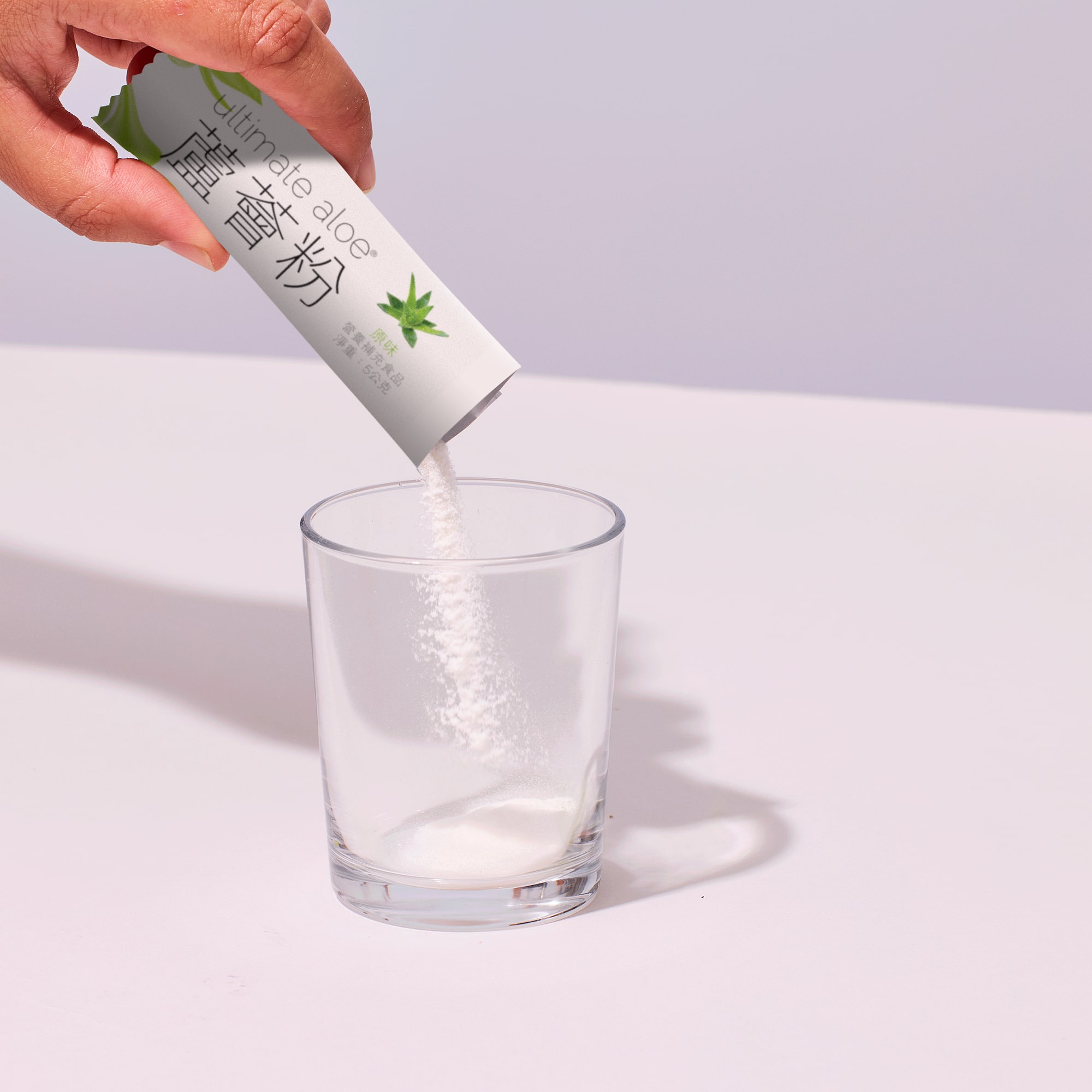 image of person adding powder to glass