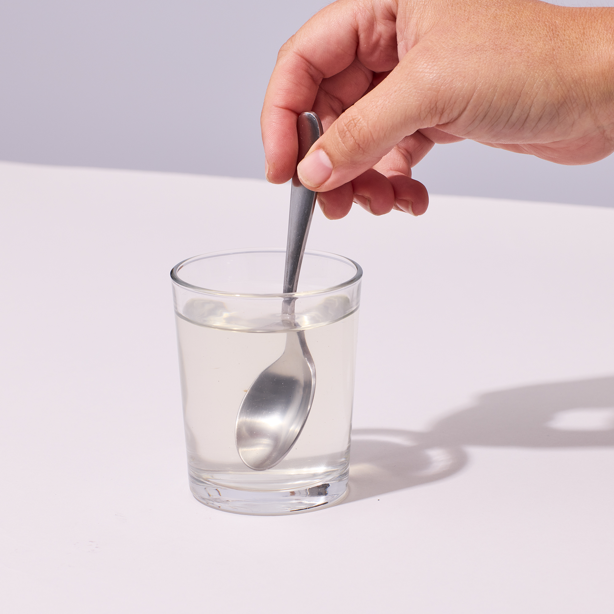 image of person stirring water and powder