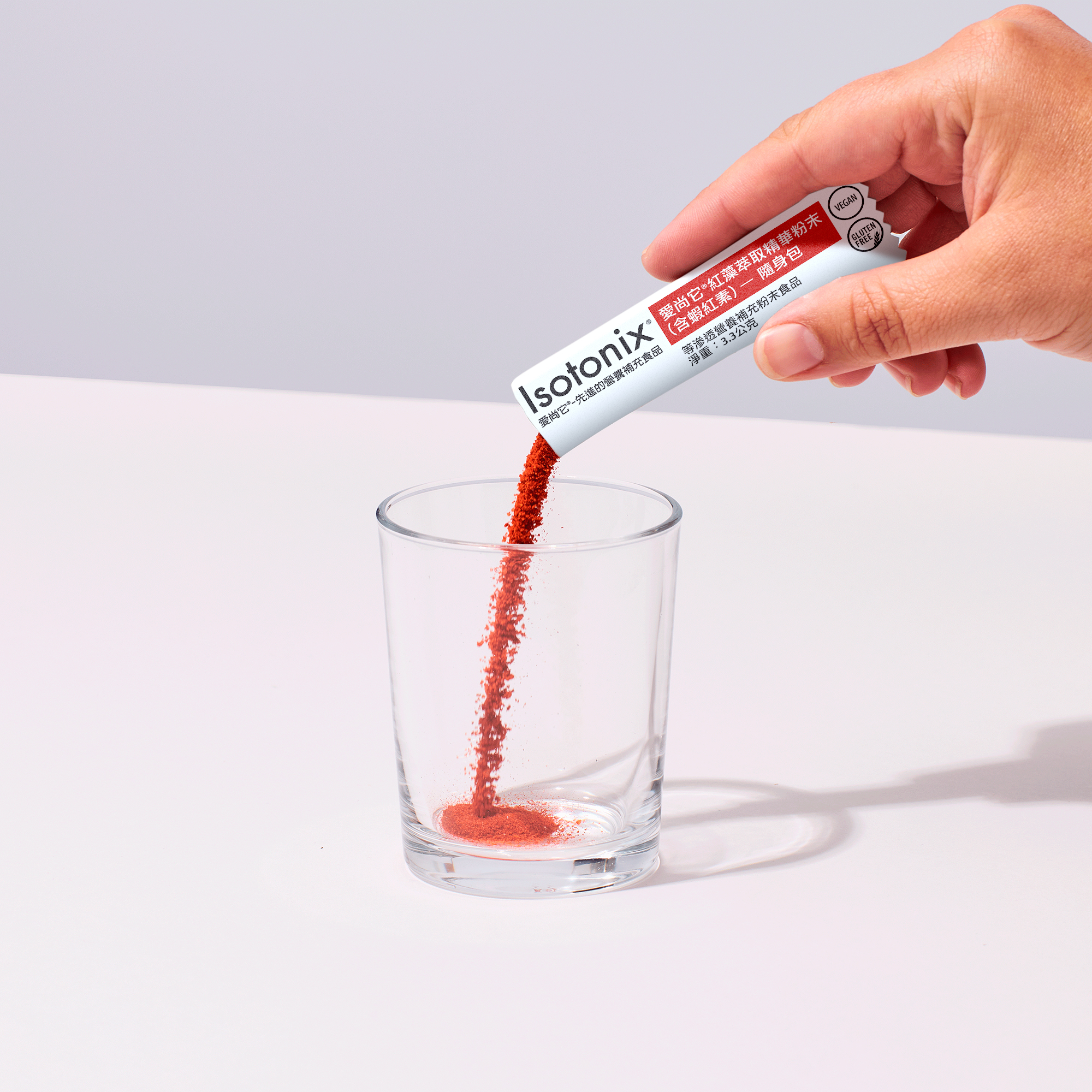 image of person adding packet of powder to glass
